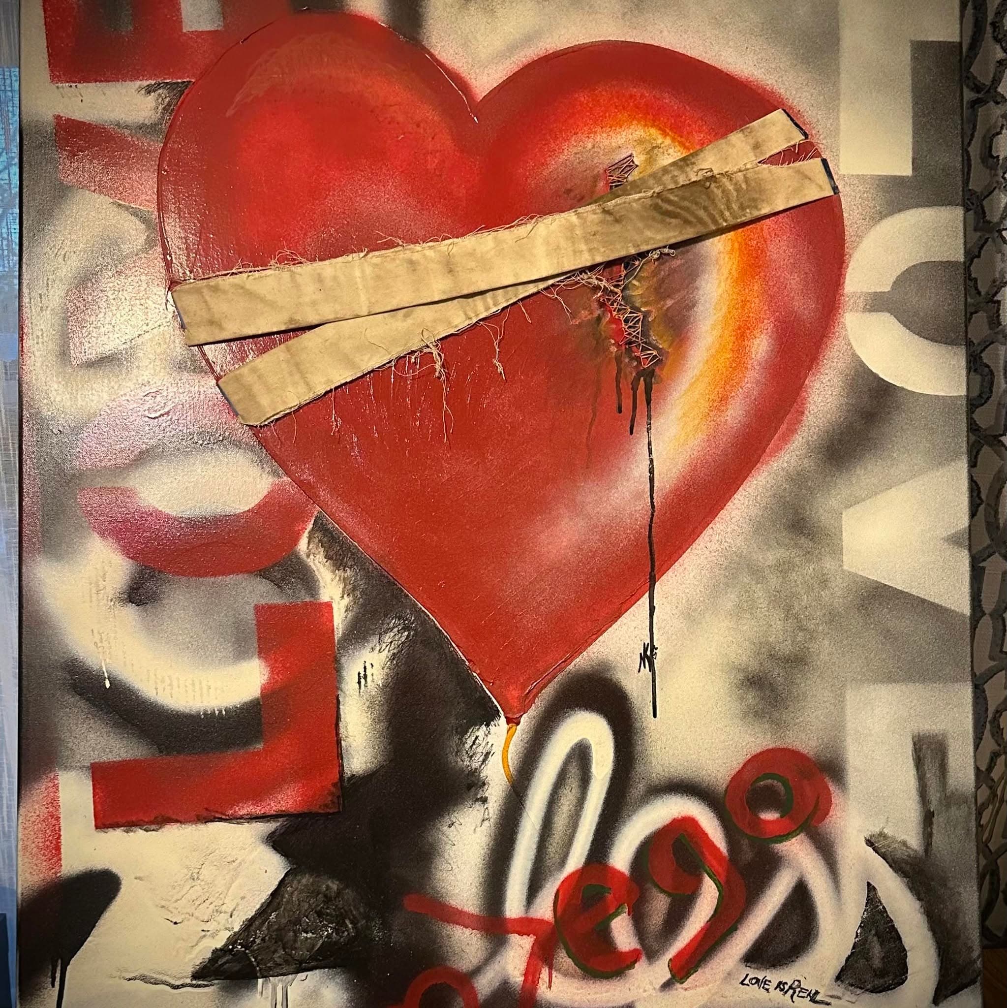 A painted red heart visibly repaired with tape and stitching, signed NK